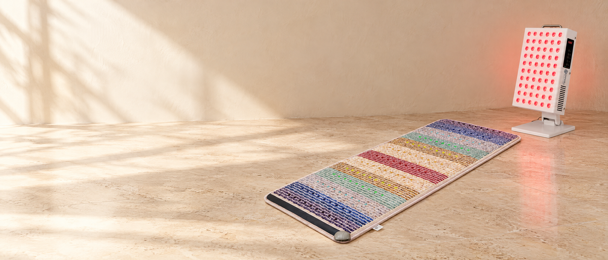 The Zenith Mat on a travertine floor beside the Radiance Panel red light, in morning light