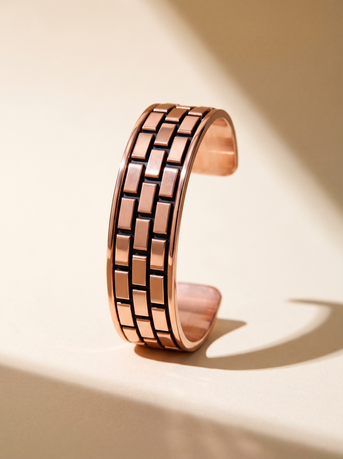 Longevity Copper Band Basketweave, three rows of raised rectangular copper tiles in an offset brick pattern with deep recessed grooves, on a warm cream studio sweep