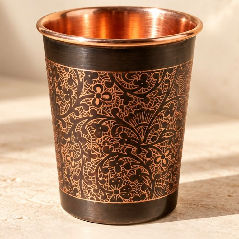 Close-up of the hand-engraved floral work on the Longevity Pure Copper Cup, polished copper rim and interior