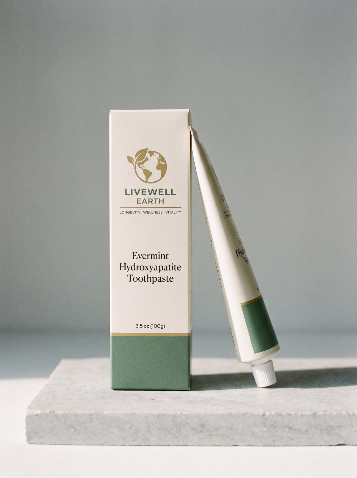 Evermint Hydroxyapatite Toothpaste carton and tube on a stone plinth, 3.5 oz (100g)