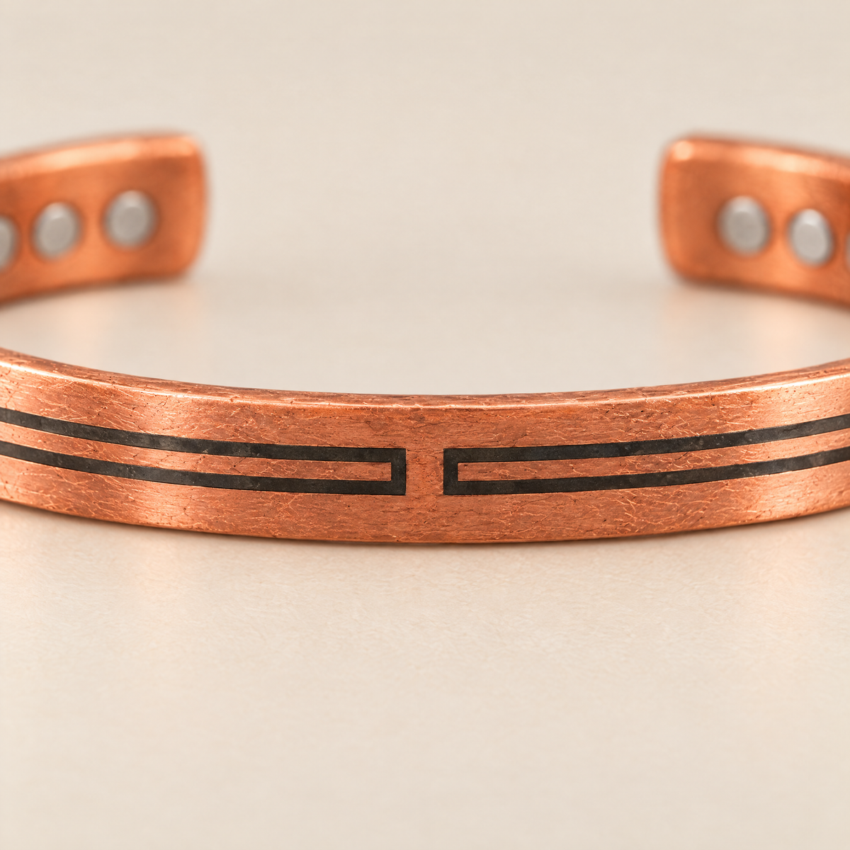 Geometric Inlay: the inlay lines closing into facing brackets across a bare copper bar at the centre