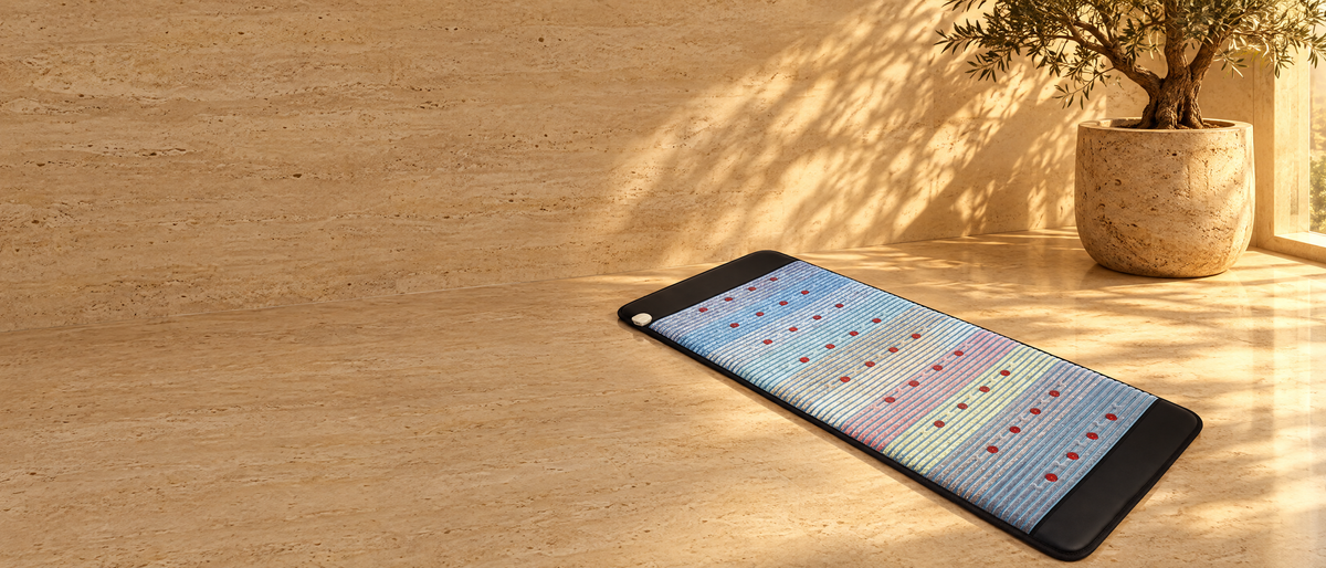 The Resonance Mat on a travertine floor in golden light