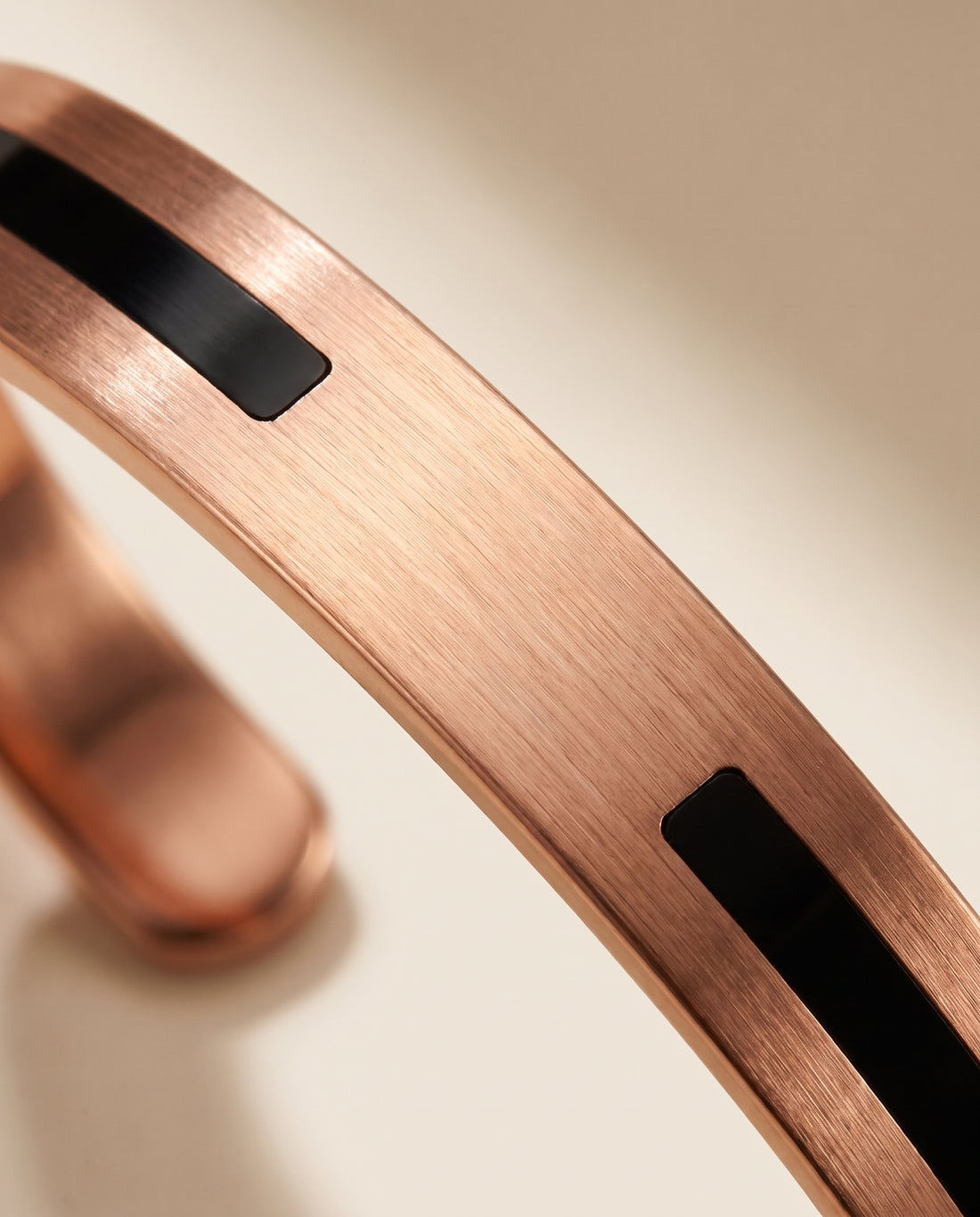 Black Segment: macro detail of two black inlay segments and the bare copper gap between them