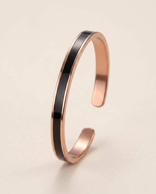 Longevity Copper Band Single Stripe, polished flat copper cuff with one continuous black inlay stripe, studio hero